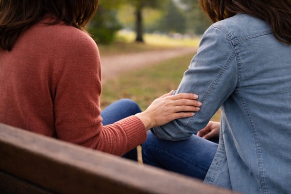 Two-people-sitting-on-a-park-bench-offering-support-before-a-Maryland-family-law-consultation-1024x683